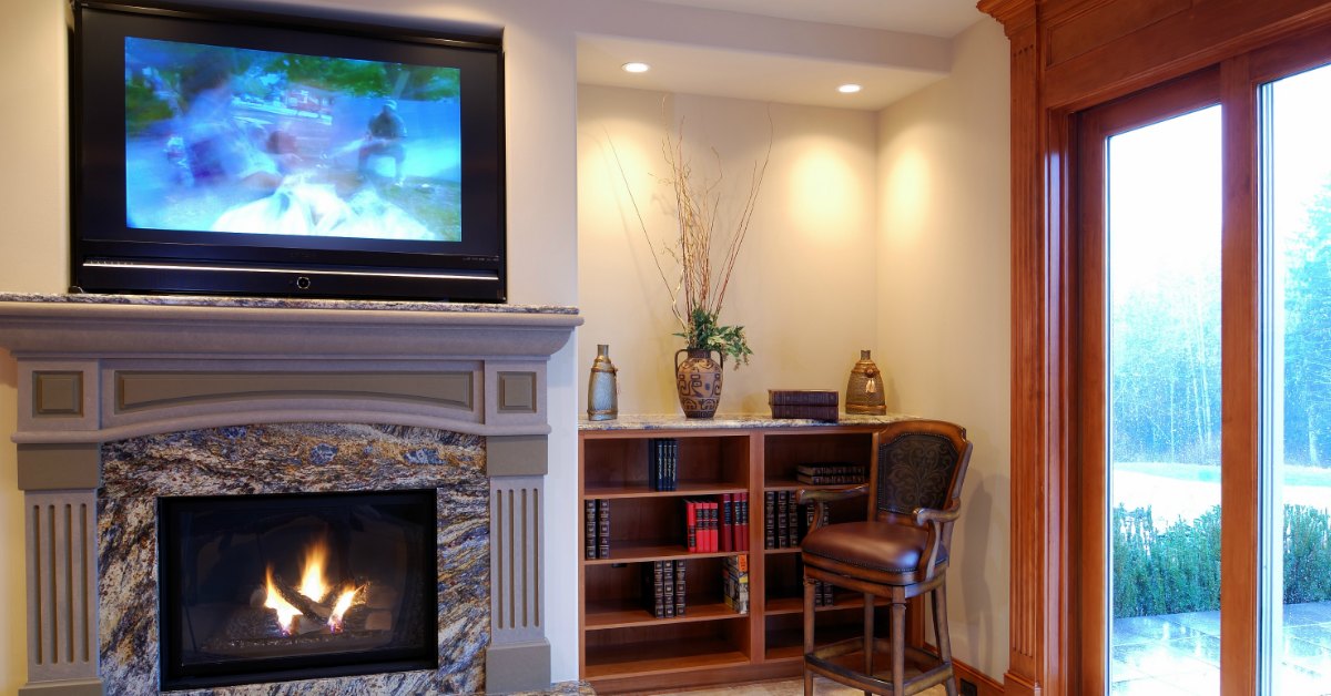 TV wall mount installation with wire concealment over fireplace